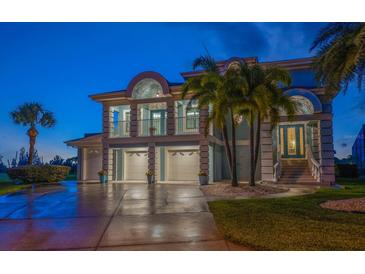 Stunning two-story coastal home boasts a three-car garage and a charming second-floor balcony at 3397 Bluefish Dr, Hernando Beach, FL 34607
