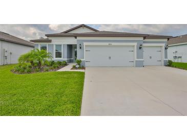 Charming single-story home featuring a three-car garage, lush lawn, and well-manicured landscaping at 3816 N Maryland Ave, Plant City, FL 33565