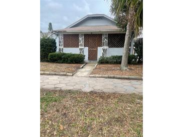 Charming bungalow exterior featuring stone accents, a covered porch, and mature landscaping at 4526 Burlington N Ave, St Petersburg, FL 33713