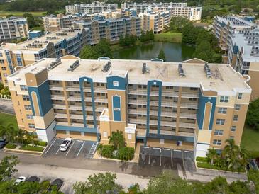 Scenic view of the apartment building with balconies overlooking the lake at 960 Starkey Rd # 2103, Largo, FL 33771