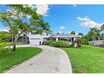 Charming two-story home with a well-maintained lawn and a winding driveway at 996 56Th S Ave, St Petersburg, FL 33705
