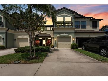 Charming two-story townhome with well-manicured landscaping and a private garage, inviting curb appeal at 11526 Crowned Sparrow Ln, Tampa, FL 33626