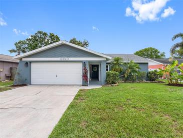 Charming single-story home with a well-maintained lawn and attached two-car garage at 12920 124Th Ave, Largo, FL 33774