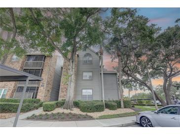 Inviting condo building with lush landscaping, mature trees, and a well-maintained exterior at 2500 Winding Creek Blvd # G307, Clearwater, FL 33761