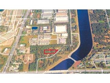 Overhead shot of land with road access, surrounded by commercial buildings and a waterway at 4210 Garden Ln, Tampa, FL 33610