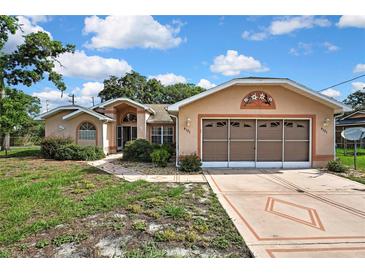 Charming single-story home with a large garage and well-maintained front yard at 6121 Piedmont Dr, Spring Hill, FL 34606