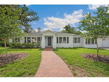 Charming single-story home with a brick walkway and well-maintained landscaping at 13917 8Th St, Dade City, FL 33525
