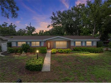 Charming single story home featuring a manicured lawn, neat landscaping and a welcoming walkway to the front door at 140 Morrow Cir, Brandon, FL 33510