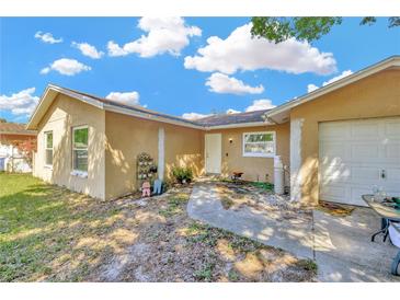 Quaint single-story home featuring a tidy front yard and neutral stucco exterior under a bright blue sky at 306 Brandywine Dr, Valrico, FL 33594