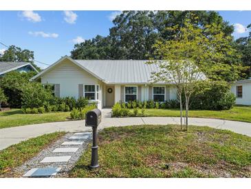 Charming single-story home with a metal roof, well-maintained landscaping, and welcoming curb appeal at 3315 W Hawthorne Rd, Tampa, FL 33611