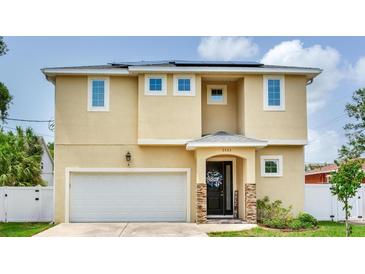 Charming two-story home featuring a welcoming front entrance and attached two-car garage at 3503 W Price Ave, Tampa, FL 33611