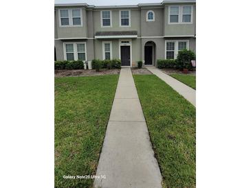 Inviting townhouse with well-maintained landscaping and neutral exterior paint at 8814 Walnut Gable Ct, Riverview, FL 33578