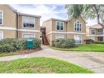 Inviting condo exterior with manicured landscaping and walkway leading to the entrance at 9481 Highland Oak Dr # 1504, Tampa, FL 33647