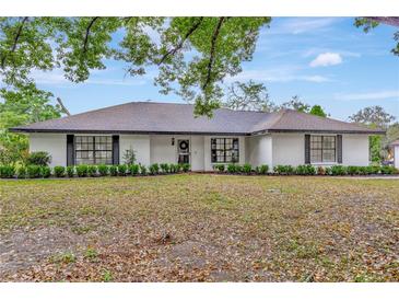 Charming single story home featuring black shutters and manicured front yard landscaping at 9615 Raiden Ln, Riverview, FL 33569
