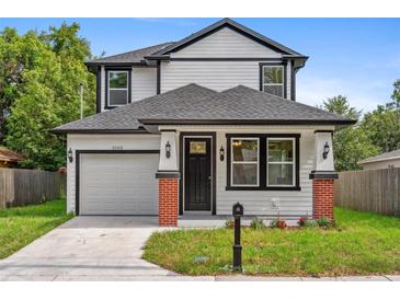 Charming two-story home with black trim, columns with brick bases, and a well-maintained lawn at 3105 E Osborne Ave, Tampa, FL 33610