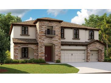 Charming two-story home with stone accents, a cozy balcony, and a well-manicured lawn at 3483 Yellow Leaf Cir, Spring Hill, FL 34609