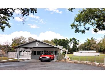Charming single-story home with a porte-cochere and well-maintained front yard at 38819 Otis Allen Rd, Zephyrhills, FL 33540