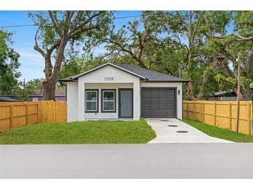 Charming single-story home with a well-manicured lawn and a one car garage at 7509 E 26Th Ave, Tampa, FL 33619