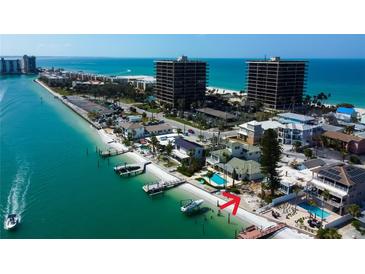 Coastal home with private beach, dock, swimming pool, and beautiful turquoise water views on a clear day at 7777 Bayshore Dr, Treasure Island, FL 33706