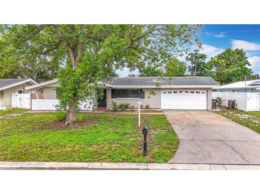 Charming single-story home with a well-maintained lawn, driveway, and attached two-car garage at 1737 Prince Philip St, Clearwater, FL 33755
