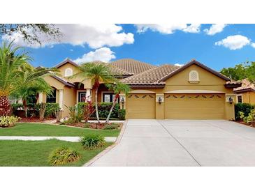 Charming single-story home with a tile roof, lush landscaping, and a spacious three-car garage at 20023 Pergola Bend Ln, Tampa, FL 33647