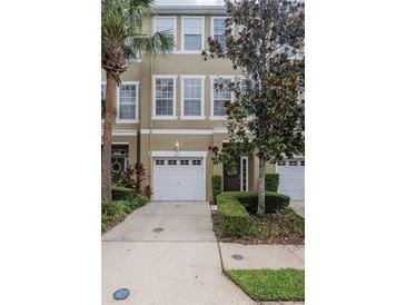 Townhome with manicured landscaping, a one-car garage, and neutral paint tones at 3053 Pointeview Dr, Tampa, FL 33611