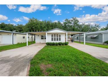 Charming single-story home featuring a covered carport, lush lawn, and welcoming curb appeal at 36701 Jodi Ave, Zephyrhills, FL 33542