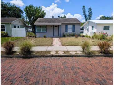 Charming single-story home featuring a walkway, tidy landscaping, and classic architectural details at 5048 5Th S Ave, St Petersburg, FL 33707