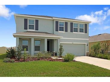 Two-story home with gray exterior paint, dark shutters, manicured lawn, and covered front porch and an attached two-car garage at 5214 Granite Dust Pl, Palmetto, FL 34221
