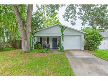 Charming single-story home with attached garage, front porch, and well-maintained lawn at 6412 S Richard Ave, Tampa, FL 33616