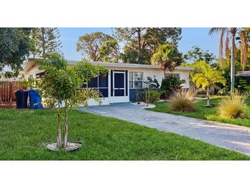Charming single-story home featuring a well-manicured lawn and a paved driveway at 6901 10Th N St, St Petersburg, FL 33702