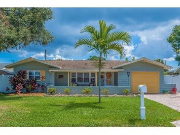 Charming single-story home with well-maintained lawn, tropical palm tree, and welcoming curb appeal at 10339 111Th St, Largo, FL 33778