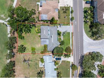 A beautiful home featuring a large lot surrounded by mature trees and meticulous landscaping at 167 Almedo Ne Way, St Petersburg, FL 33704