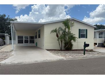 Charming single-story home with a carport, tidy landscaping, and classic design, creating a welcoming curb appeal at 250 S Port Royal Ln, Apollo Beach, FL 33572
