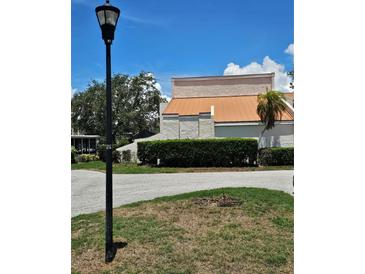 Inviting exterior view showcasing the well-maintained landscaping and architecture under a bright, sunny sky at 4304 Harbor House Dr, Tampa, FL 33615