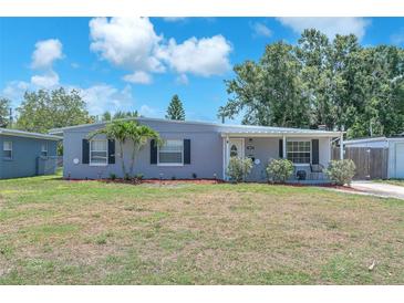 Charming single-story home featuring a well-maintained lawn and classic architectural details at 5927 10Th N St, St Petersburg, FL 33703