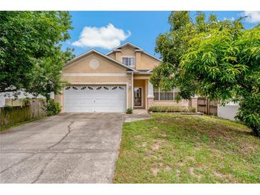 Charming two-story home with a well-maintained lawn, inviting curb appeal, and attached two-car garage at 6625 Interbay Blvd, Tampa, FL 33611