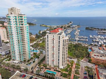 Breathtaking aerial view of waterfront condo towers with marina, offering luxury living and stunning ocean views at 100 Beach Ne Dr # 301, St Petersburg, FL 33701