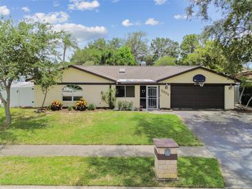 Charming single-story home with a well-maintained lawn and a two-car garage at 12306 91St Ter, Seminole, FL 33772