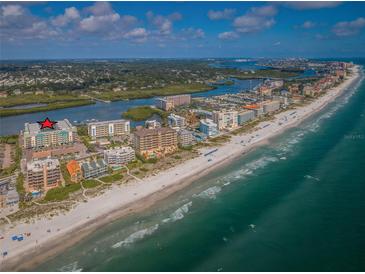 Aerial view showcasing beachfront condos near the coastline at 19531 Gulf Blvd # 306, Indian Shores, FL 33785
