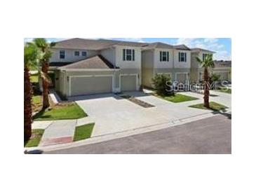 A well maintained townhome with attached garages and neatly landscaped yards at 2822 Jacob Crossing Ln, Holiday, FL 34691