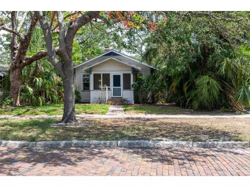 Charming bungalow-style home with a brick sidewalk and lush, mature landscaping at 317 19Th S Ave, St Petersburg, FL 33705
