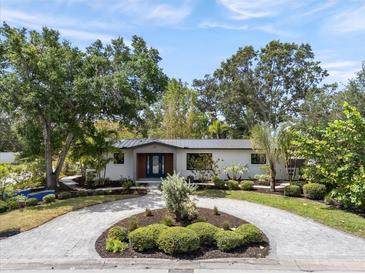 Beautiful home with circular driveway, mature landscaping, and modern exterior design at 454 35Th Ne Ave, St Petersburg, FL 33704