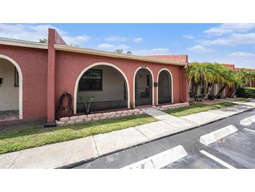 Charming single-story villa with arched entryway and well-maintained landscaping at 6346 Bonnie Bay N Cir, Pinellas Park, FL 33781