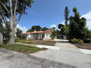 Charming single-Gathering home featuring a clay tile roof, white stucco, and a spacious front yard at 737 19Th N Ave, St Petersburg, FL 33704