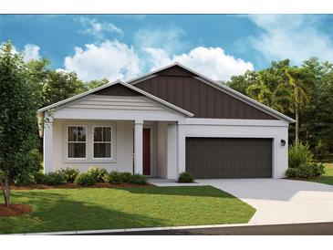 Charming single-story home with a well-manicured lawn and a two-car garage at 12114 Cattleside Dr, Riverview, FL 33579