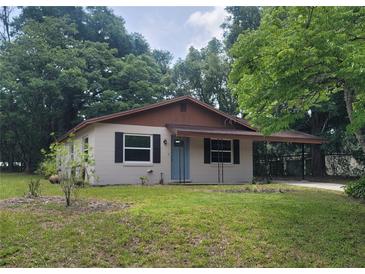 Charming single story home with lush green lawn and inviting curb appeal at 21352 Lehouier Dr, Brooksville, FL 34601