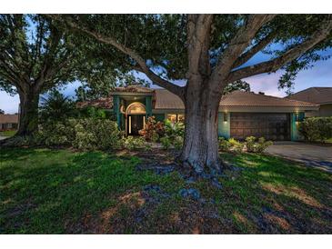 Charming home with lush landscaping, mature trees, and a well-maintained lawn at 2459 Parkstream Ave, Clearwater, FL 33759