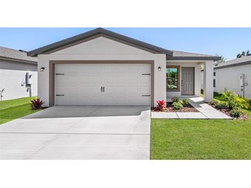 Beautiful home featuring an attached two car garage and a well manicured front yard at 29563 Fedora Cir, Brooksville, FL 34602