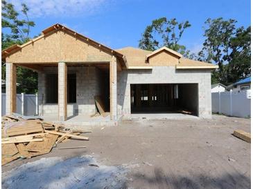 Exterior view of a home under construction showing the frame and foundation work in progress, garage entrance, and basic structure at 3110 19Th N St, St Petersburg, FL 33713